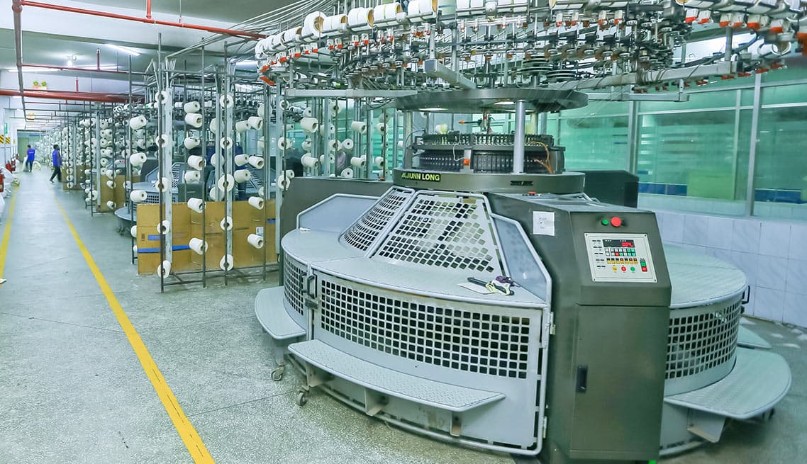 Knitting machines producing fabric at Mamun Knitwear Ltd.